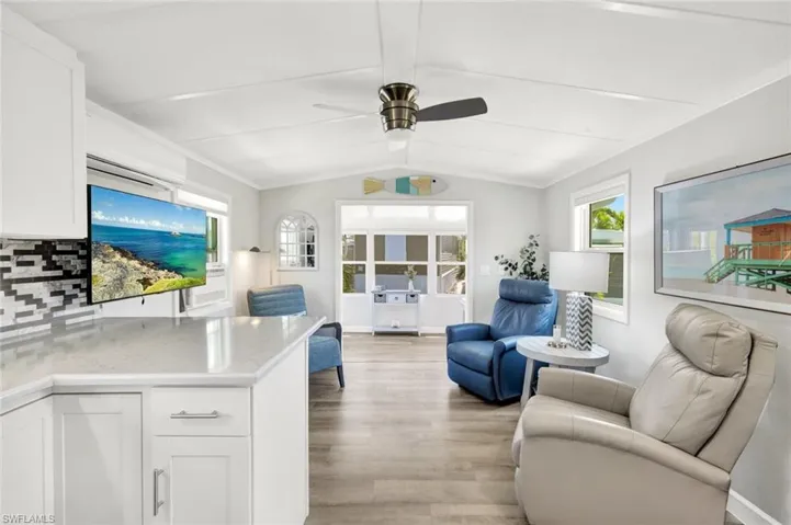 View of living area and enclosed porch from kitchen.