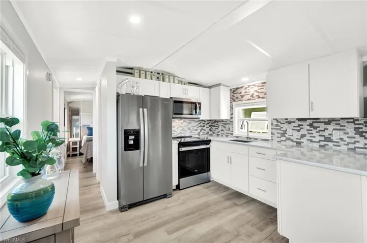 Kitchen features stainless appliances, shaker cabinets and plenty of storage space!