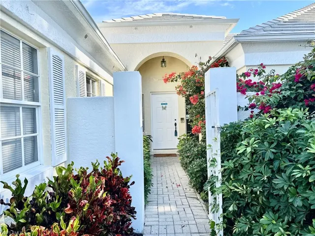 Entrance to property with stucco siding