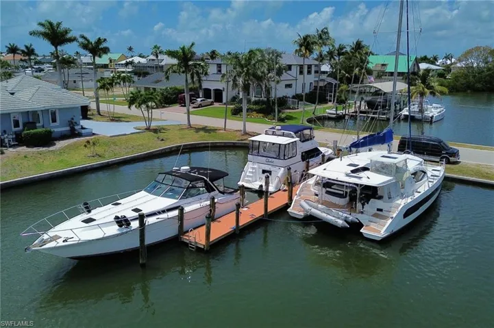 Dock area with a water view and a residential view