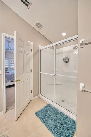 Full bath with a shower stall, light tile patterned floors, ensuite bathroom, and recessed lighting