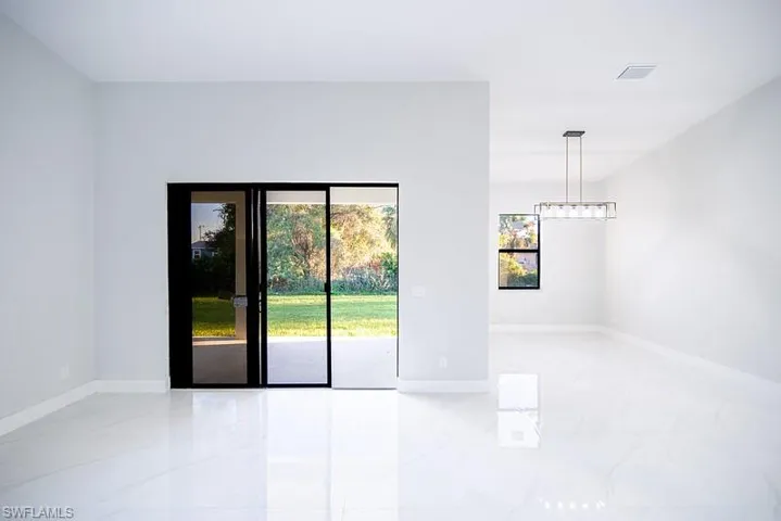 Empty room featuring baseboards and light marble finish flooring