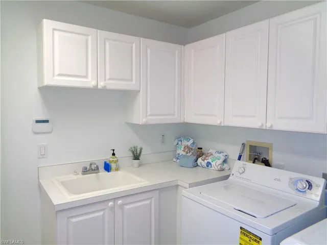 Laundry room featuring washer / clothes dryer and cabinet space