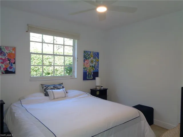 Bedroom featuring ceiling fan and baseboards