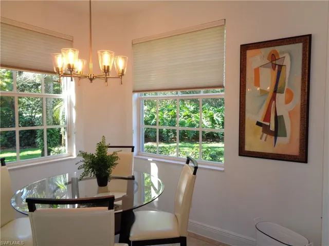 Dining area with a chandelier and baseboards