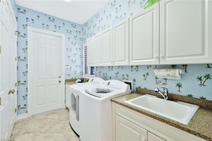 Utility room w/ full-wall storage closets