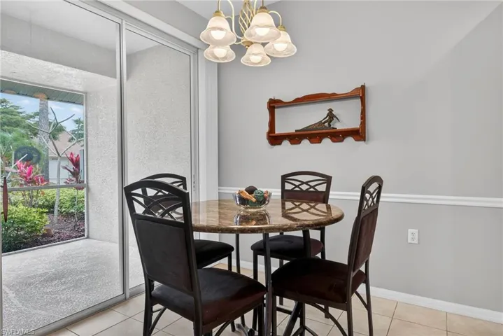 Dining space featuring a chandelier and light tile patterned flooring