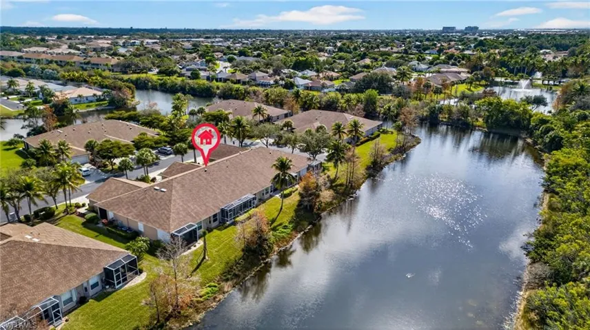 Aerial view of property and surrounding area with a large body of water