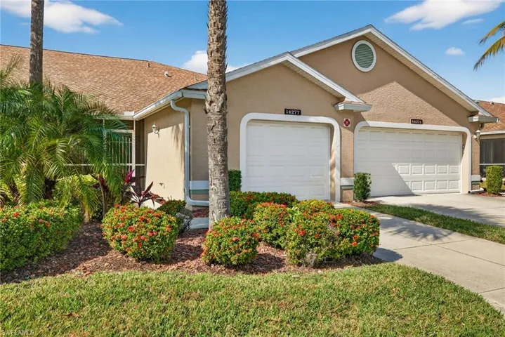 View of front of house featuring stucco siding, concrete driveway, and an attached garage