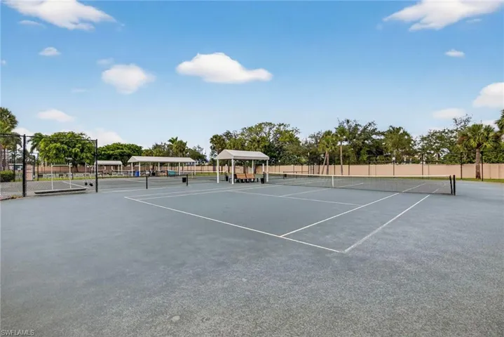 View of tennis court featuring community basketball court and a gazebo