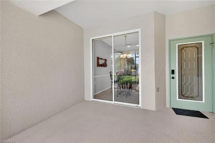 Entrance to property with stucco siding