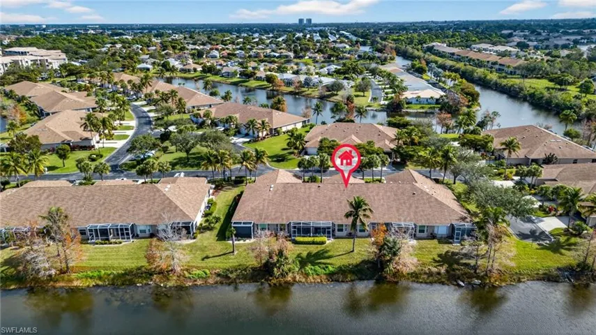 Aerial overview of property's location with a large body of water and nearby suburban area