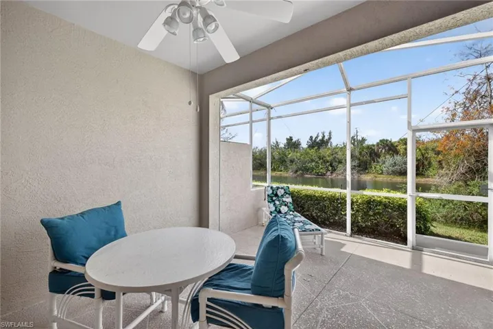 Sunroom / solarium with ceiling fan, a patio, and a water view