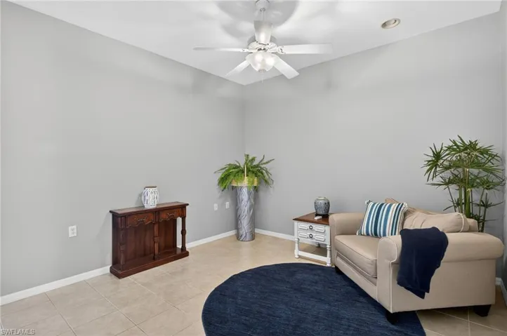 Sitting room with baseboards and a ceiling fan
