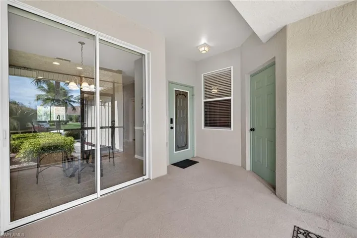 Property entrance featuring stucco siding