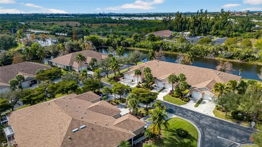 Aerial overview of property's location with a nearby body of water and a tree filled landscape