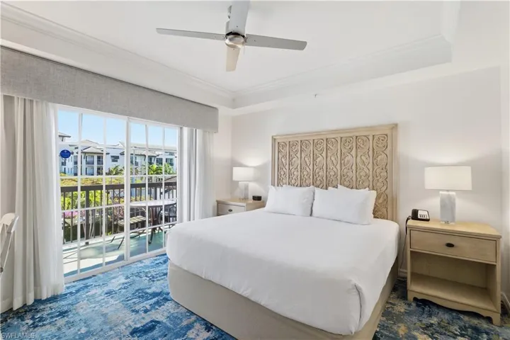 Bedroom featuring crown molding, access to outside, ceiling fan, and a tray ceiling