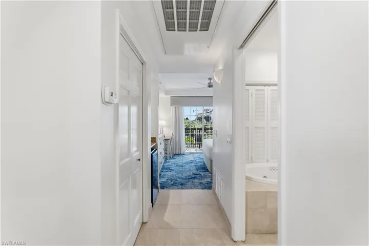 Hallway featuring light tile patterned floors