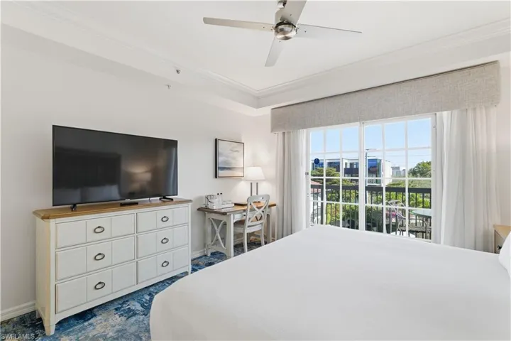 Bedroom featuring access to outside, ornamental molding, ceiling fan, and a desk