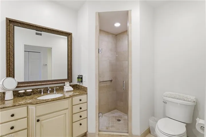 Full bath with a shower stall and vanity