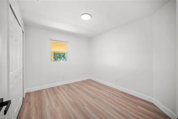 Unfurnished bedroom with light wood-style flooring and a closet