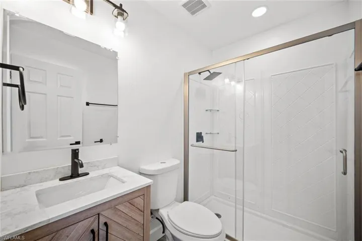 Bathroom with vanity and a shower stall