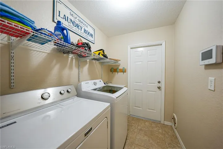 Laundry area featuring washer and dryer and a textured ceiling
