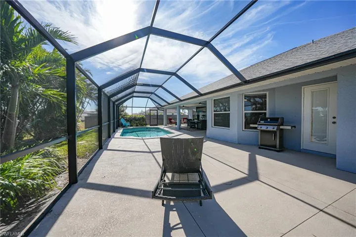 View of patio / terrace featuring glass enclosure and grilling area