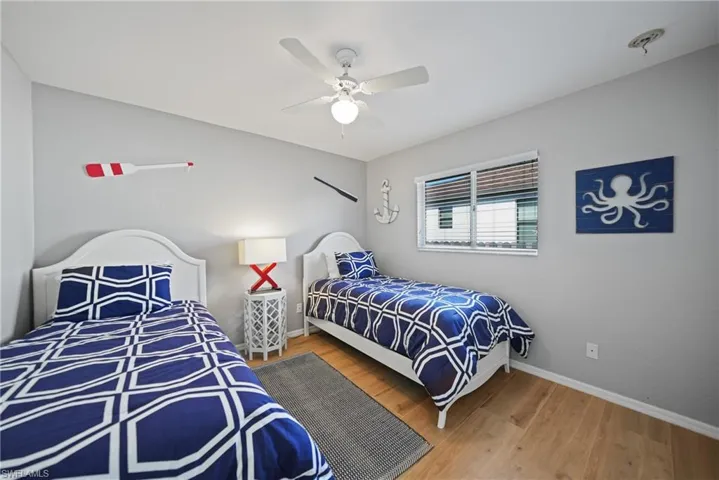 Bedroom with ceiling fan and hardwood / wood-style flooring