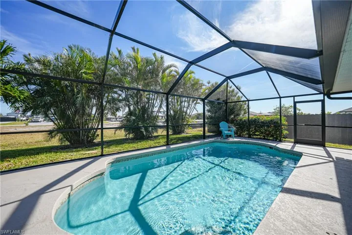 View of swimming pool featuring a patio and a lanai