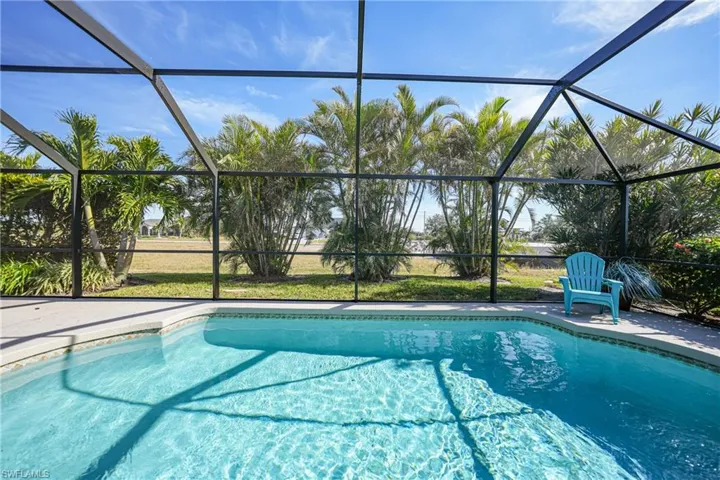 View of swimming pool featuring glass enclosure