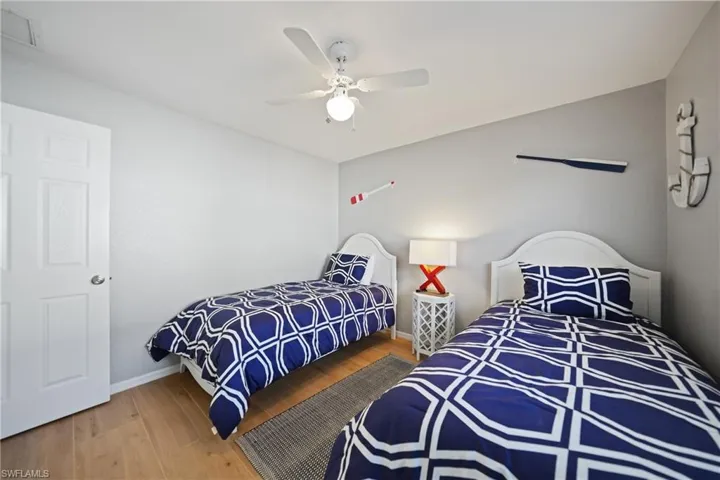 Bedroom featuring wood-type flooring and ceiling fan