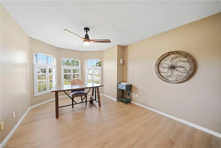 Office featuring ceiling fan and light hardwood / wood-style floors
