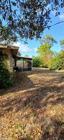 View of yard with a sunroom