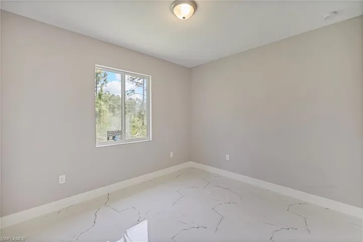 Unfurnished bedroom with baseboards, a closet, and marble finish floor