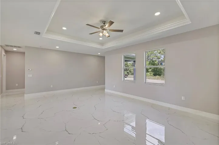 Kitchen with appliances with stainless steel finishes, light stone counters, marble finish floor, recessed lighting, and baseboards