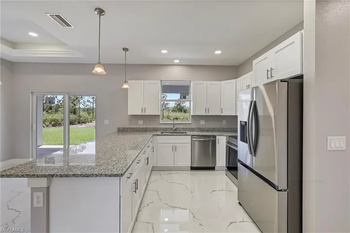 Empty room with marble finish floor, a ceiling fan, recessed lighting, baseboards, and a tray ceiling
