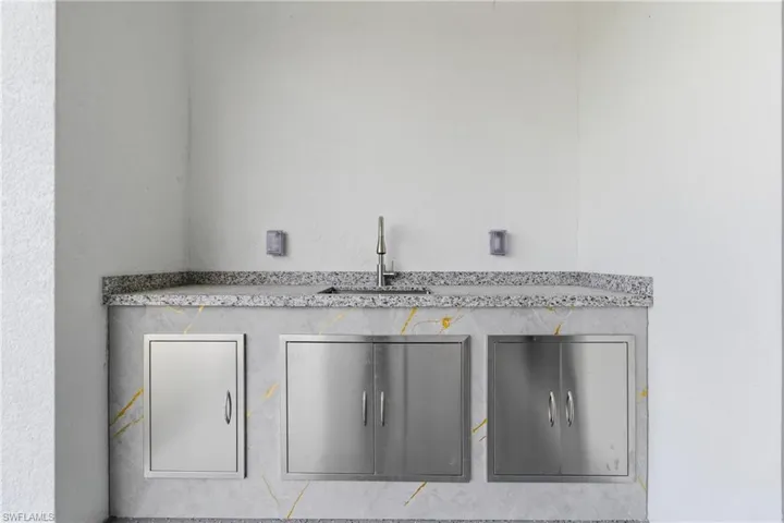 Detailed view of a sink and a textured wall