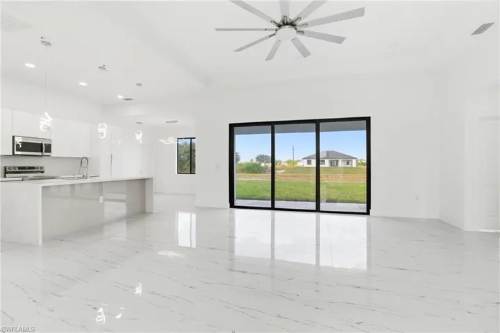 Unfurnished living room featuring recessed lighting and ceiling fan