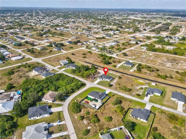 Aerial overview of property's location featuring nearby suburban area