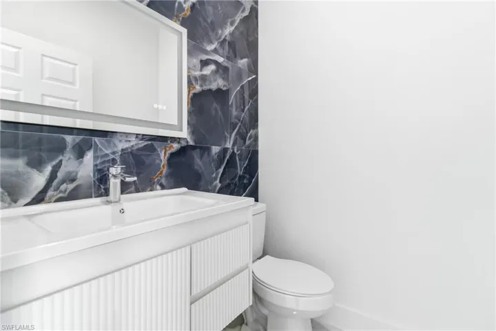 Bathroom featuring vanity and tile walls
