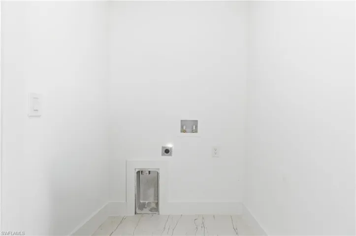 Laundry room featuring hookup for a washing machine, electric dryer hookup, and light marble finish flooring