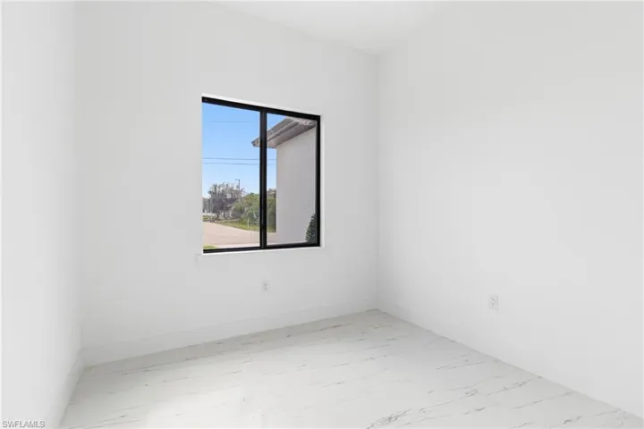 Empty room with light marble finish floors and baseboards