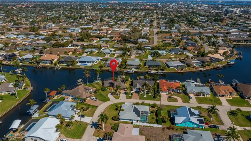 Aerial overview of property's location featuring nearby suburban area and a nearby body of water