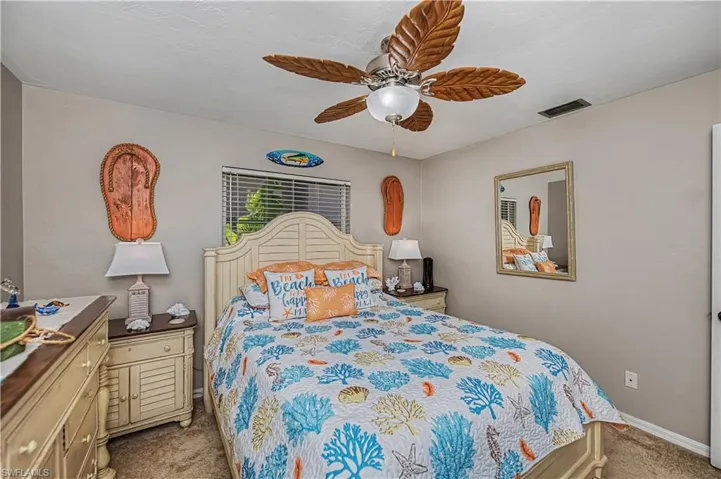 Bedroom with a ceiling fan and carpet floors