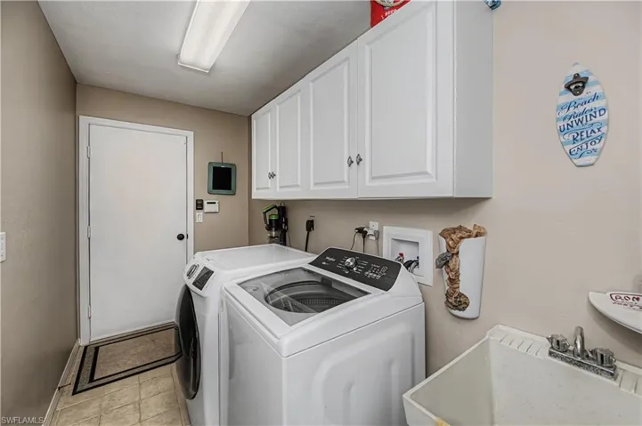 Laundry room with cabinet space and washing machine and dryer