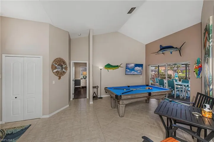 Playroom featuring billiards table, lofted ceiling, and light tile patterned floors