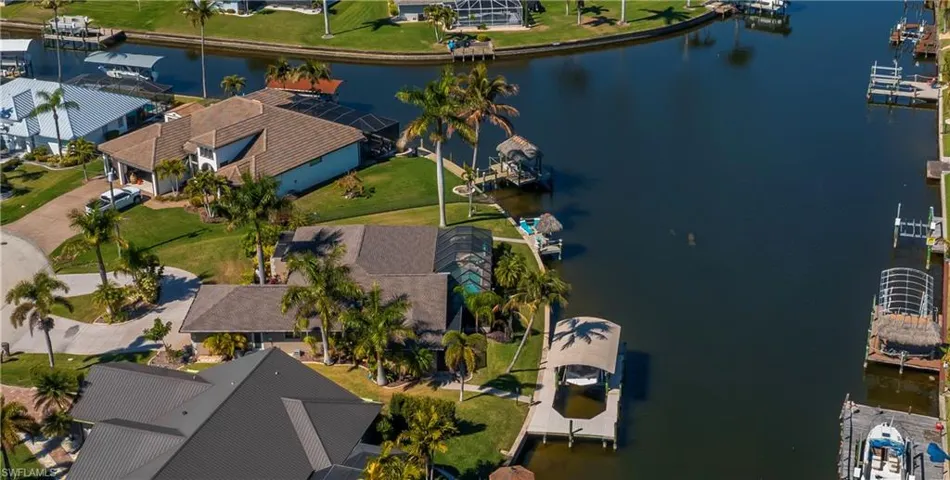 Aerial perspective of suburban area featuring a large body of water