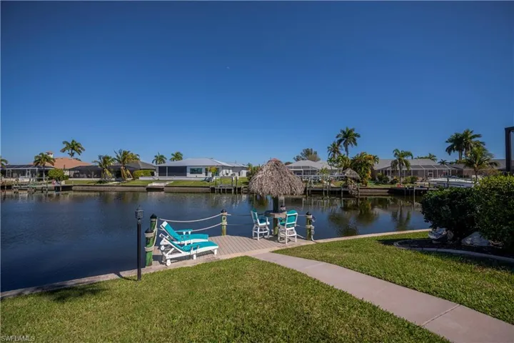 Dock area featuring a residential view, a lawn, and a water view