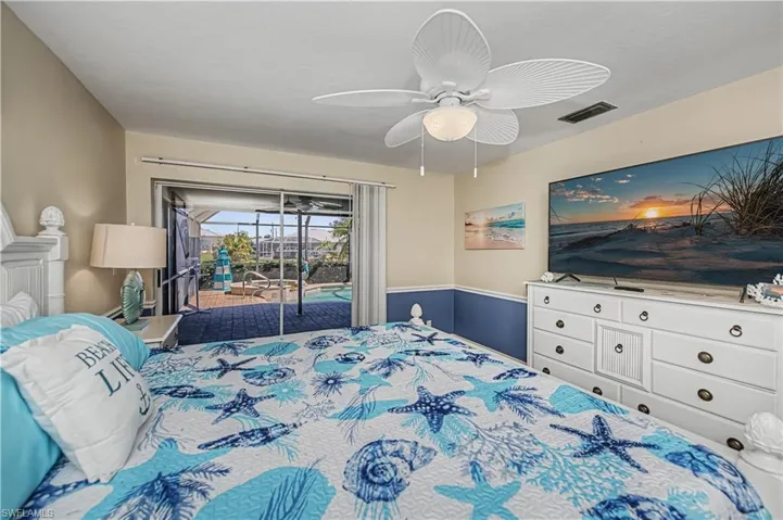 Bedroom with access to outside, a ceiling fan, and a sunroom